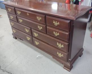 Wooden dresser with gold colored hardware 