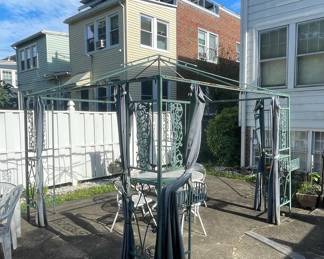 Wrought Iron Gazebo with Scrolled Metalwork and Curtains