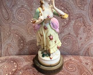Porcelain Figurine of a Woman with Flower Basket