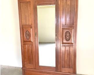 Antique Solid Wood Armoire with Hand Carved Medallions and Cherub Face Hardware