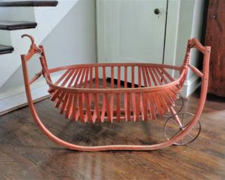 1886 Field cradle made of wood with metal wheels.