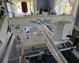 King Quilter Special Edition longarm quilting machine, featuring a white body and prominent branding.The system includes a 18x8 inch throat space, mounted on a frame, excellent working condition!!