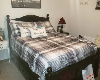 Full size bed with mattress and large storage drawers below plus matching nightstand 