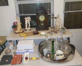 Crystal decanters, clock, statues, Kindles, large silver colored tray and perfumes