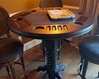 Game table with that flips to become a plain table with 3. Ballard stools