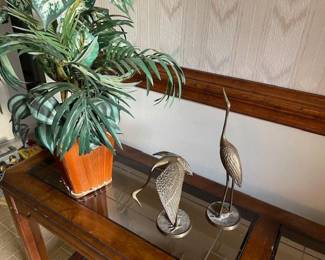 Brass cranes, faux greenery
