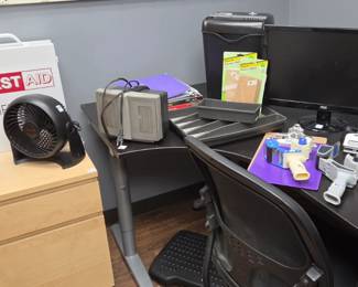 Large Metal wall-mounted first aid kit Small fans portable heaters Desk drawers Desks and chairs