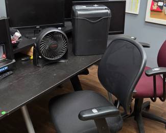 Desks chairs computer monitors paper shredder Small fans And other Office Necessities