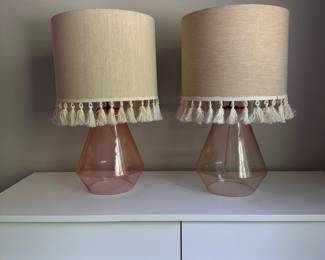 F56 - $25 Each. Pink Lamps - 2 available. Same style but slightly different colors. Measures 22.5" tall. Shades are both in good condition. Lamp bases are glass and are open on the bottom.