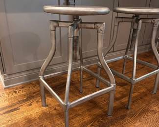 F44 - $175 PAIR. Crate & Barrel Turner Gunmetal Adjustable Backless Counter Stools. Seats are 13" round. Adjusts from 24-30" tall. Includes seat covers for both.