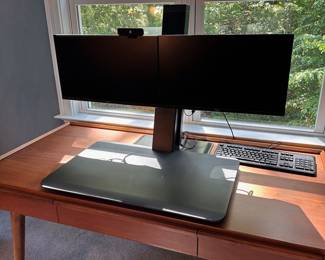F54 - $100. Dual Monitor Workstation. Monitors NOT included. Adjusts from sitting to standing height.