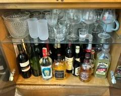 Liquor cabinet and various crystal ware / glasses.