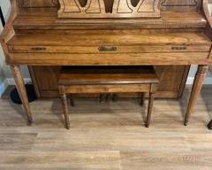 Schafer & Sons oak console piano with matching bench.