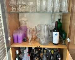 Liquor cabinet and various crystal ware / glasses.