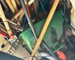 Various gardening tools and seed spreader.