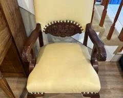 Victoria-style armchair, dark mahogany frame w/ lion head carvings.