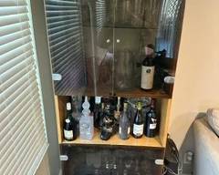 Liquor cabinet and various crystal ware / glasses.