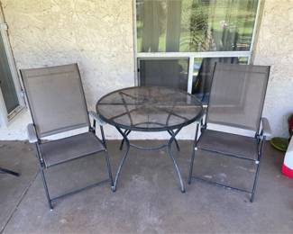 Two Folding Chairs And A Table