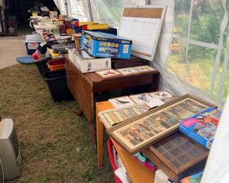 Vintage tables with books, games, and collectibles