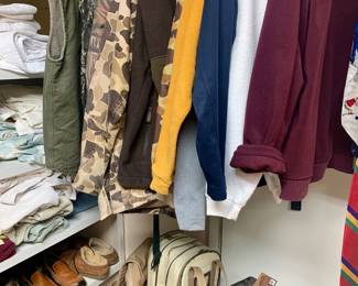 closet filled with fine men's clothes including hunting clothes