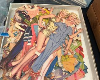 Large box of vintage paper dolls with clothes