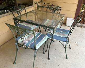 Matching wrought iron glass top table and chairs