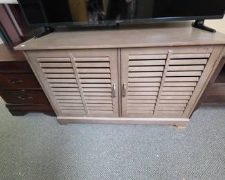 Gray Wood Laminate Entertainment Center (some damage on front foot and some writing in marker on the front top corner). 2 Shelves inside but no shelf pegs