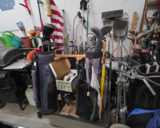 Golf Cady and lots of Golf Clubs.