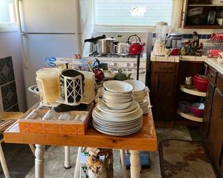 table with 4 chairs, dishes, teapots