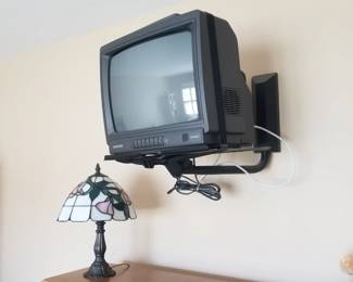TV with bracket; table lamp