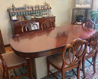 Antique dining set, including table and chairs with shell-back design.