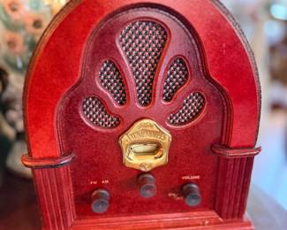 Red cathedral-style radio with peacock-fan grille