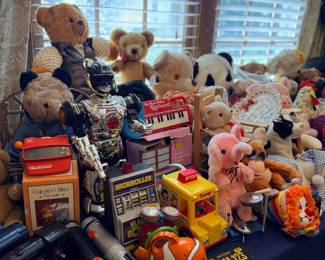 Table of teddy bears and toy vehicles