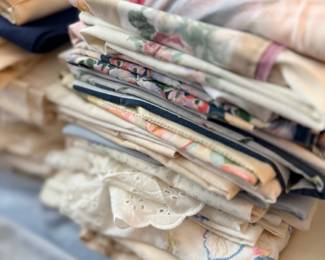 Stack of folded tablecloths and embroidered linens