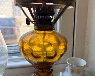 Antique amber glass oil lamp with brass burner