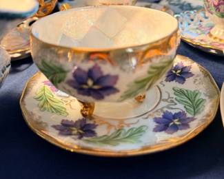 Hand-painted porcelain teacup and saucer, violets and gold