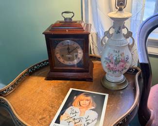 Side table with mantel clock and porcelain lamp