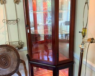 Lighted mahogany curio cabinet with glass shelves