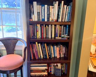 Tall wood bookcase filled with books