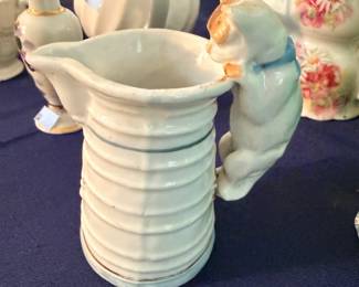 Assorted ceramic pitchers and creamers