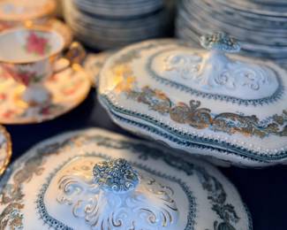 Blue and gold covered serving dishes and plates
