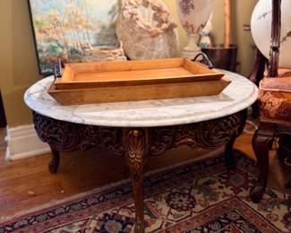 Oval marble-top carved coffee table