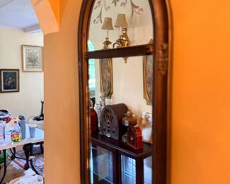 Arched wood-framed wall mirror with etched glass