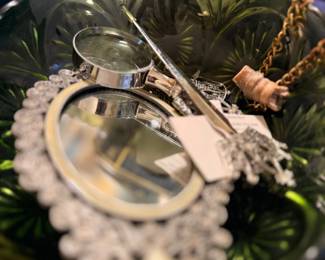 Glass vanity dish with hand mirror and jewelry