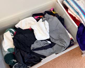 Bin of folded clothing