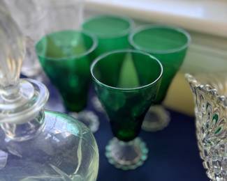 Green glass goblets and pressed glass dishes