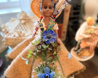 Folk art doll with raffia dress and flowers
