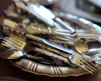 Stacked silver flatware forks, spoons and knives