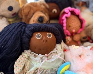 Cabbage Patch-style doll and plush animals