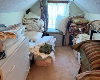 Attic room with linens, dresser and furniture